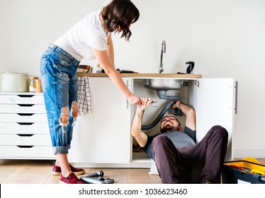 Couple Fixing Kitchen Sink