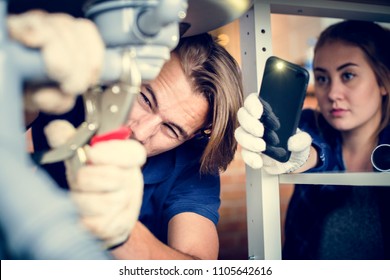 Couple Fixing Kitchen Sink