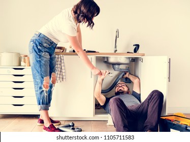 Couple Fixing Kitchen Sink