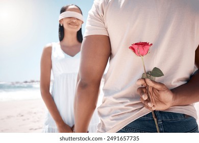 Couple, flower and blind fold at beach as surprise for love on honeymoon and holiday in Bali. People, relationship and smile or happy for anniversary celebration on vacation, break and bonding