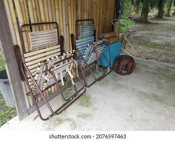 Couple Of Folded Old Lazy Chair At The Wooden Shed.