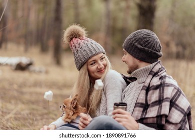Couple in the forest grills marshmallows