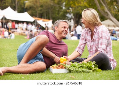 Couple With Fresh Produce Bought At Outdoor Farmers Market