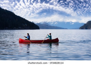 Couple friends canoeing on a wooden canoe