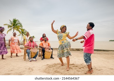 Couple Of Friends Dancing To The Rhythm Of Punta Music, On A Guatemalan Caribbean Beach.