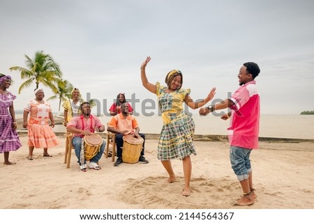 Couple of friends dancing to the rhythm of Punta music, on a Guatemalan Caribbean beach.