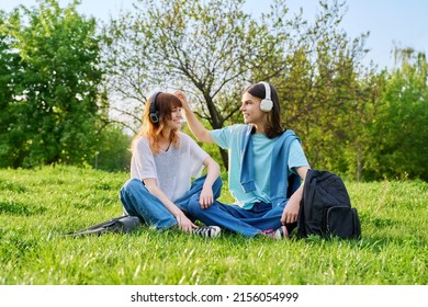 Couple Of Friends Guy And Girl 17, 18 Years Old Sitting On Grass