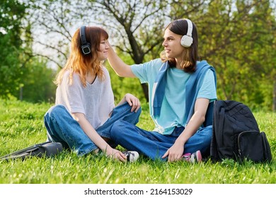 Couple Of Friends Guy And Girl 17, 18 Years Old Sitting On Grass