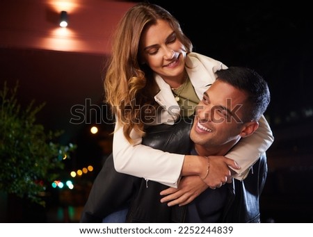 Couple of friends, piggyback and fun night on city street or road in birthday celebration, romance date and goofy game. Smile, happy and man carrying woman on back in comic activity and silly bonding