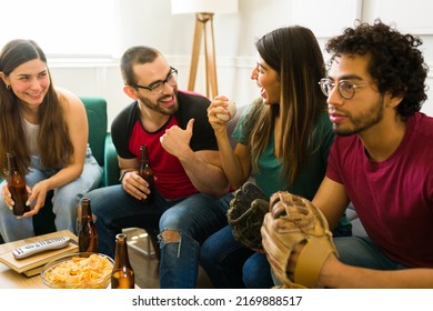 Couple Of Friends Watching A Baseball Game On The Tv While Enjoying Beer And Snacks