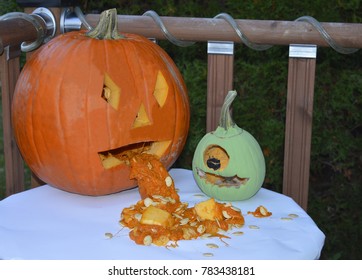 A Couple Of Funny Haloween Pumkin Buddies Sitting On A Table Waiting For Darkness To Scare The Trick Or Treaters.