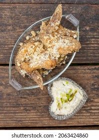 A Couple Of Garlic Parmesan Chicken Wings In A Glass Platter Served With Ranch Dip In A Heart Shaped Bowl.