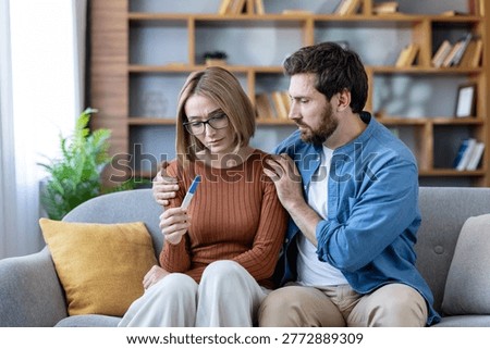 Couple getting devastating news from a negative at-home pregnancy test, a man comforting his sad wife experiencing infertility issues and disappointment while trying to conceive