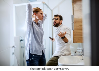 Couple Getting Ready For Work And They Are Arguing. Bathroom Interior, Morning Time.