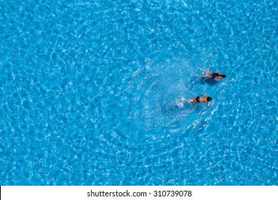 Couple Girls Swim In The Pool At The Hotel. View From Above. 