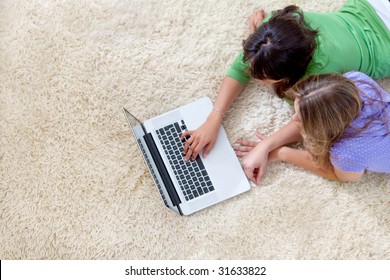 Couple Of Girls Working On A Laptop Computer