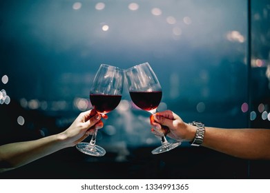 Couple With Glasses Of Red Wine In Luxury Restaurant.couple With Glasses Of Red Wine In Sky Bar