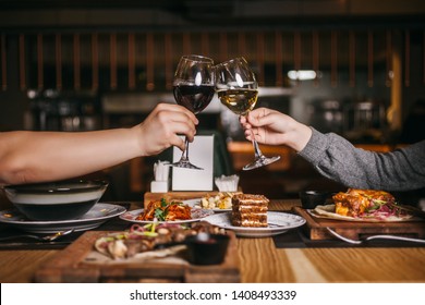 Couple with glasses of wine and desserts