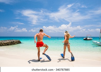 Couple is going to swim and snorkel. - Shutterstock ID 340787885