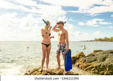 Couple Is Going To Swim And Snorkle On Hawaii Beach