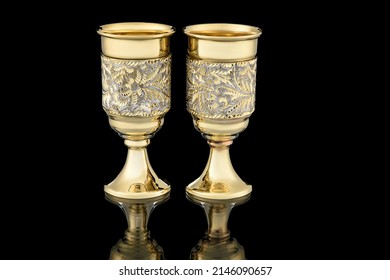 Couple Golden Antique Vintage Brass Shot Glass Gilded On Black Background. Metal Wine Cup Goblet With Carving Engraving Pattern.