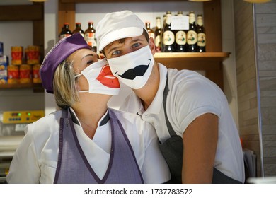 Couple Grocery Store Clerks With A Fun Protective Mask Covid-19. Turin, Italy - May 2020