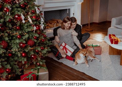 Couple guy and girl with dog in New Year and Christmas time. - Powered by Shutterstock