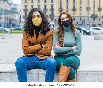 Couple Of Guys With Face Mask And With Folded Arms. Angry And Fed Up With The Coronavirus Pandemic.