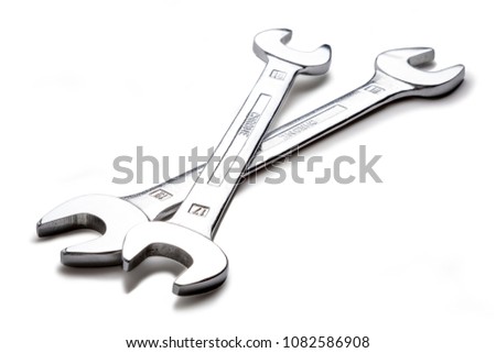 A couple of hand spanner tools, shot on white, with a drop shadow.