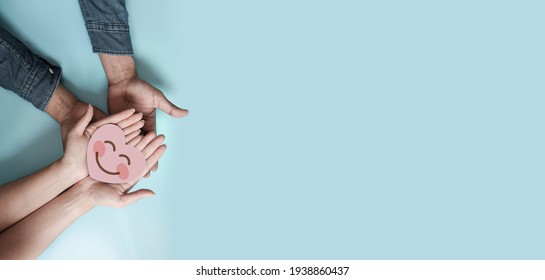 Couple hands holding paper cut red heart, family insurance, CSR, world heart day, health care, love, organ donation,  world health day, wellbeing, gratitude, be kind, be thankful, praying concept