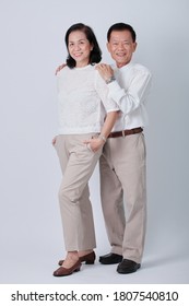 Couple Of Happy Asian Old Woman And Old Man Standing In Studio White Background.