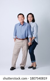 Couple Of Happy Asian Old Woman And Old Man Standing In Studio White Background.