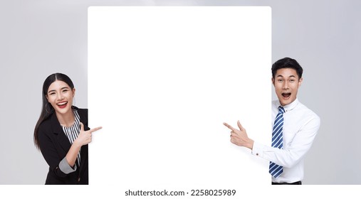 Couple Happy business asian people hand pointing blank announcement banner isolated on studio white background. - Powered by Shutterstock