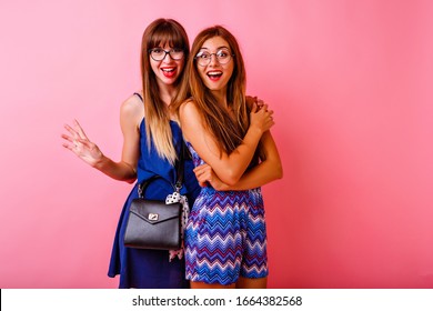 Couple Of Happy Positive Beat Friends Sister Girls Posing At Studio Pink Background, Color Matching Navy Trendy Outfits, Hugs And Smiling, Surprised Emotions, Two Lady Together.