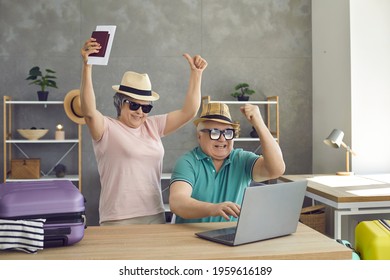 Couple of happy senior travelers find good cheap accommodation for summer holiday. Excited old husband and wife getting ready for vacation trip, shopping online and browsing hot sale website on laptop