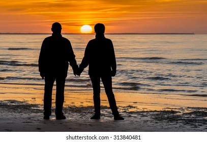 Couple of happy seniors at sandy beach of the Baltic Sea - Powered by Shutterstock