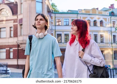Couple Of Happy Teenage Friends Walking Holding Hands, Outdoor