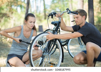 Couple Have A Flat Tyre With Mountain Bike Outdoor