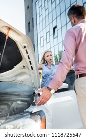 Couple Having Argument At Broken Car On Street