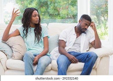 Couple having argument on the couch at home in the living room