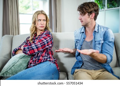 Couple having an argument on the sofa - Powered by Shutterstock