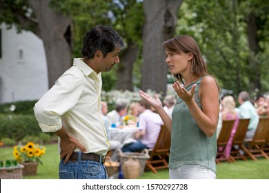 A couple having an argument at a summer party - Powered by Shutterstock