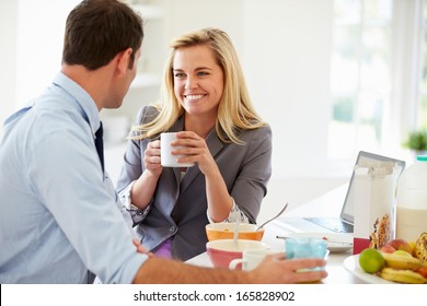 Couple Having Breakfast Together Before Leaving For Work