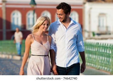 Couple Having A City Break In Summer Walking In The Evening Light