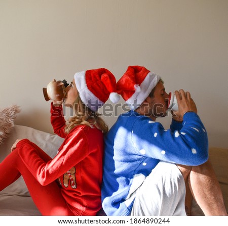 Couple having a coffee on the sofa during the Christmas holidays.