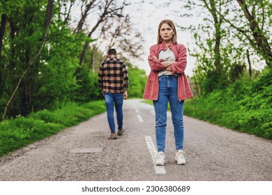 Couple is having difficulties in their relationship. Man is leaving his woman after argue. Conceptual image.