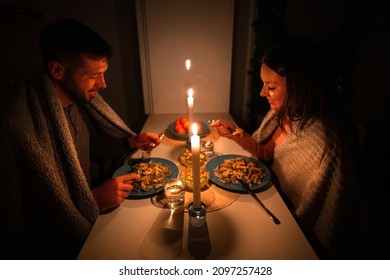 Couple Having Dinner At Home During Power Outage. Blackout, No Electricity