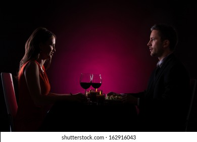 Couple Having Dinner With Wine Glass On Table
