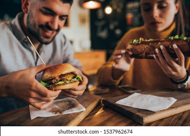 couple having fun eating in food corner bar