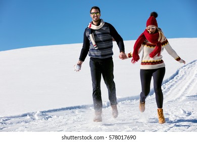 Couple having fun running down slope